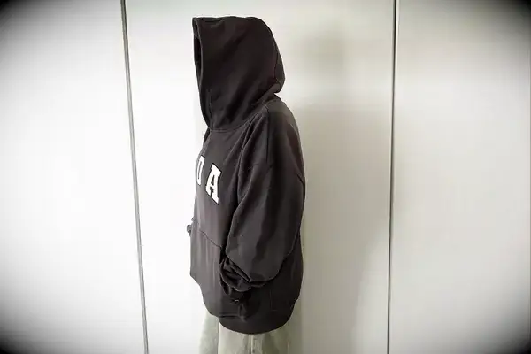 A person standing to the side wearing the Adanola ADA Oversized Hoodie