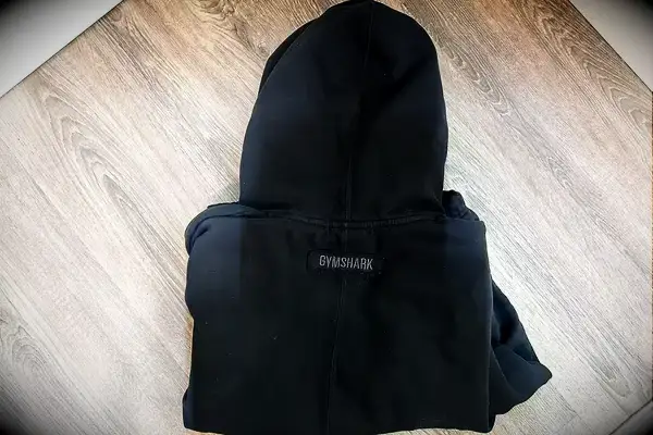 Gymshark Fleece Oversized Hoodie folded up on a wood surface