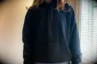 A person wearing the Gymshark Fleece Oversized Hoodie