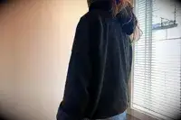 A person wearing the Gymshark Fleece Oversized Hoodie