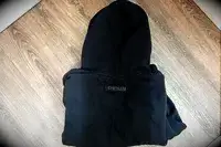 Gymshark Fleece Oversized Hoodie folded up on a wood surface