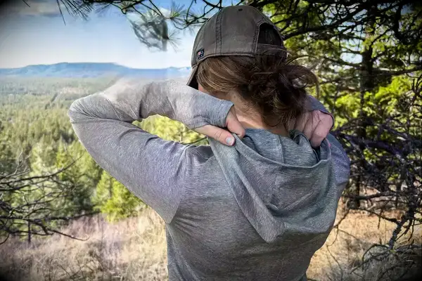 Woman outdoors wearing an Outdoor Research Activeice Spectrum Sun Hoodie