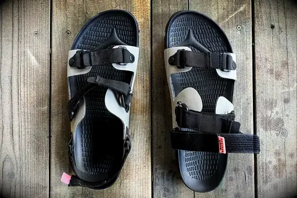 Quoc x Restrap Sandals on a wooden surface