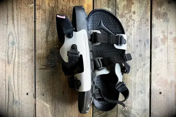 Quoc x Restrap Sandal with straps displayed on a wooden surface