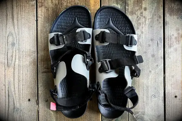 Quoc x Restrap Sandals with adjustable straps on a wooden surface