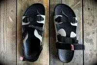 Quoc x Restrap Sandals on a wooden surface