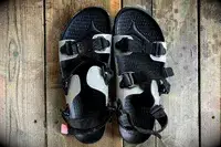 Quoc x Restrap Sandals with adjustable straps on a wooden surface