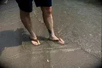Person wearing Olukai Tuahine Flip Flop at the beach