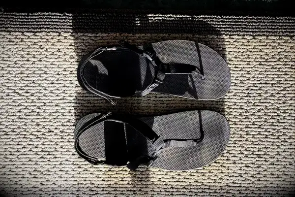 Bedrock Cairn Adventure Sandals sitting on a woven mat