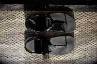 Bedrock Cairn Adventure Sandals sitting on a woven mat