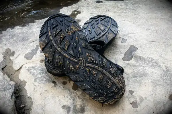 The soles of wet and sandy Chaco Men