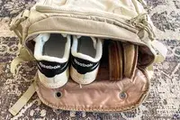 Photo of top of backpack with shoes in the bag