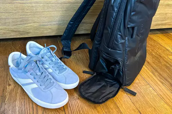 Photo of shoes next to the calpak luka backpack