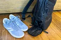 Photo of shoes next to the calpak luka backpack