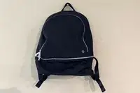 lululemon City Adventurer Backpack hanging on a hook on a wall