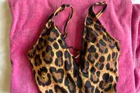 A TA3 Brazilian Plungey Swimsuit on a pink towel