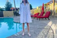 Woman wears Tommy Bahama Cotton Clip Jacquard Cover-up Shirt Dress next to a pool