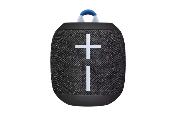 Hand holding a Gaiatop Portable Handheld Folding Fan against a beach and ocean backdrop