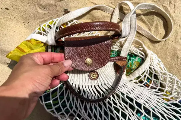 The leather strap on the Longchamp Le Pliage Filet L Mesh Bag