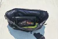 The Case-Mate Pelican Marine IP68 Waterproof Phone Pouch in a bag resting on concrete