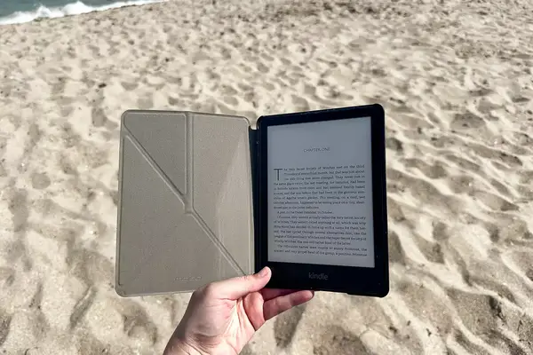 A person holds the Moko Case for Kindle Paperwhite Origami Standing Shell Cover