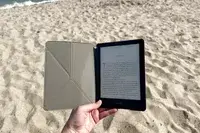 A person holds the Moko Case for Kindle Paperwhite Origami Standing Shell Cover