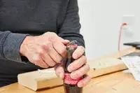 Topeak Mini 18+ Multi-Tool is being used to open a bottle cap