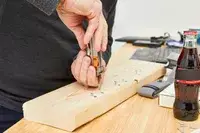 Leatherman Free P4 Multi-Tool is being used to fix a nail on wooden plank