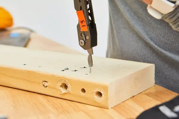 Gerber Gear Dime Multi-Tool is used to fix nail on wooden plank