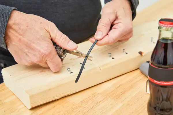 Leatherman Wave Multi-tool is being used to cut a wire