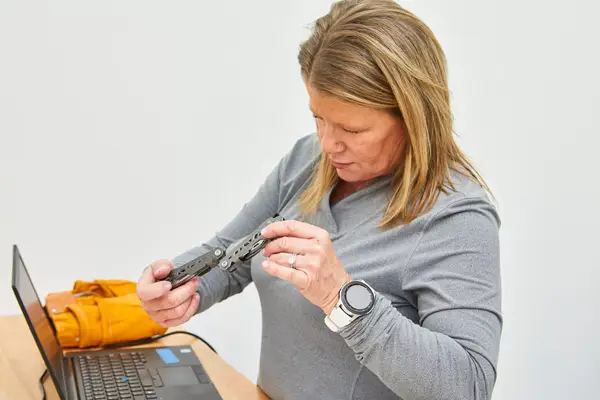 Women holding Gerber Gear Truss Multi-Tool while testing