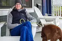 A person sits in a chair while wearing the L.L. Bean Women
