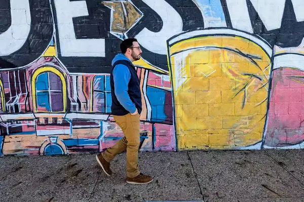 A person walks down a street while wearing the Patagonia Men