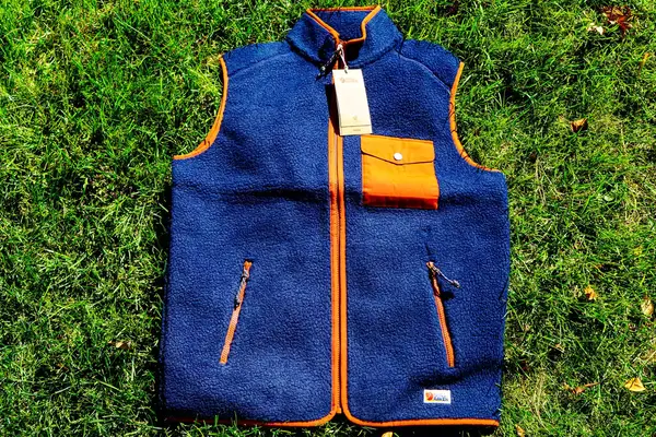 The Fjallraven Men’s Vardag Pile Fleece Vest on grass