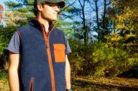 A person wears the Fjallraven Men’s Vardag Pile Fleece Vest outside
