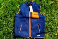 The Fjallraven Men’s Vardag Pile Fleece Vest on grass