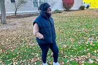 A person wears the Alo Incline Puffer Vest outside