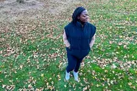 A person wears the Alo Incline Puffer Vest outside