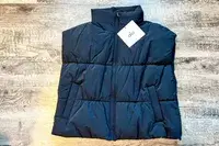 The Alo Incline Puffer Vest with the tags on