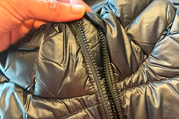 A person holds up a zipper on the Columbia Women