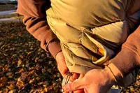 A person cinches the drawstring on the bottom of the Eddie Bauer Men