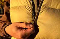 A person unzips the Eddie Bauer Men