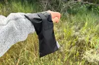 Someone holds a pair of sunglasses in a case