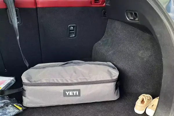A Yeti Lowlands Blanket in its bag in a car trunk