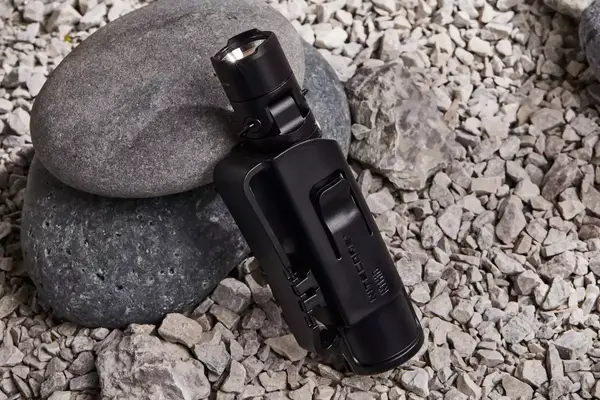 Nitecore MT21C Rechargeable Flashlight in carrying holster displayed on rocks