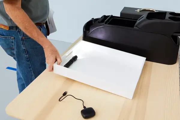 Nitecore MT21C Rechargeable Flashlight displayed in white tray on wood table