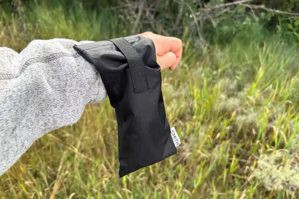 Someone holds a pair of sunglasses in a case