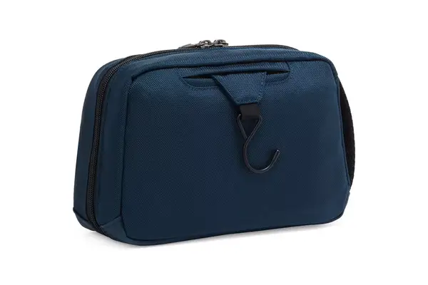 A person removes items from the Thule Aion Toiletry Bag