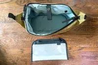 The Thule Aion Toiletry Bag open and empty with a pocket separator removed