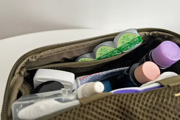 Toiletry items inside the Dagne Dover Small Seoul Dopp Kit